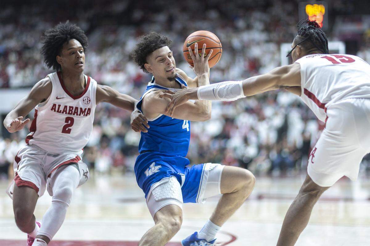Kentucky guard Koby Brea (4) looks to move the ball as Alabama guard Aden Holloway (2) and forward Jarin Stevenson (15) defend during Saturday’s game at Coleman Coliseum in Tuscaloosa, Ala.