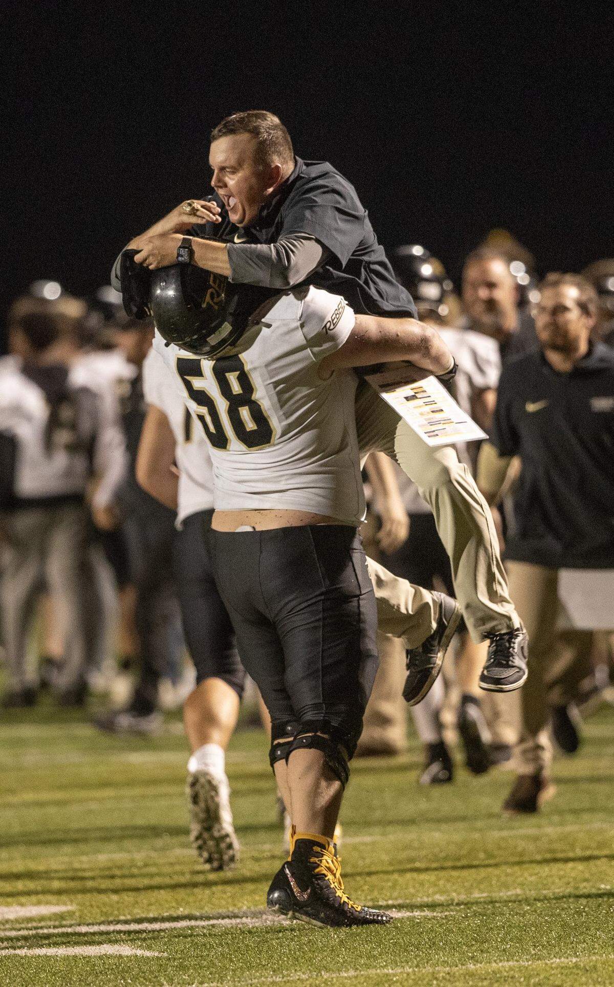 Boyle County lineman Austin Gorley gives head coach Justin Haddix a celebratory lift after the Rebels’ 28-7 win over Frederick Douglass in Lexington on Friday night.