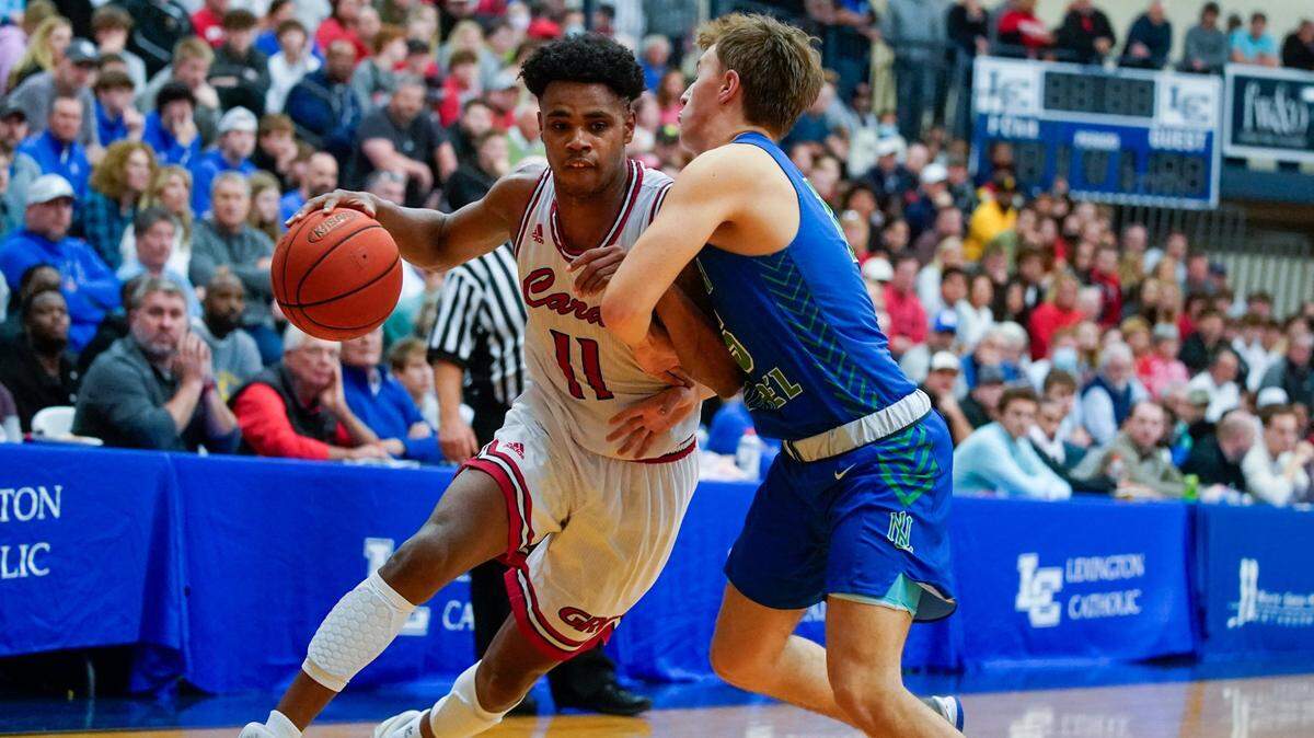 Clark County’s Jerone Morton (11) drove against North Laurel’s Kyler Elza (15) during the White, Greer & Maggard Orthodontics Holiday Classic at Lexington Catholic on Dec. 28, 2021. Clark County won 77-64.