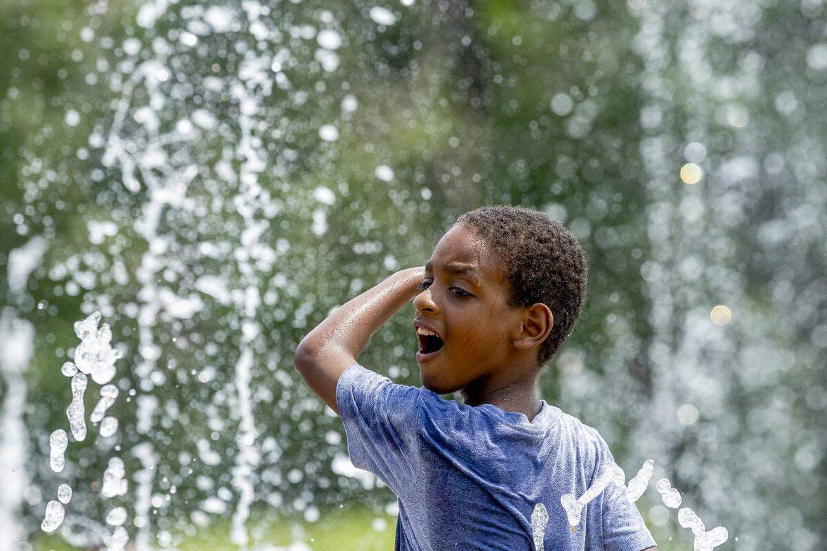 Jayden Smith, 7, of Lexington cools down at the Jacobson Park sprayground on Monday, June 17, 2024. With Tuesday temperatures forecasted to be 96 degrees, places like the sprayground are a good place for kids to cool down.