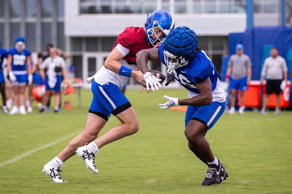 Quarterback Cutter Boley hands the ball off to running back Jason Patterson during a Kentucky practice. Patterson, a true freshman, could be a contributor in the backfield this season.