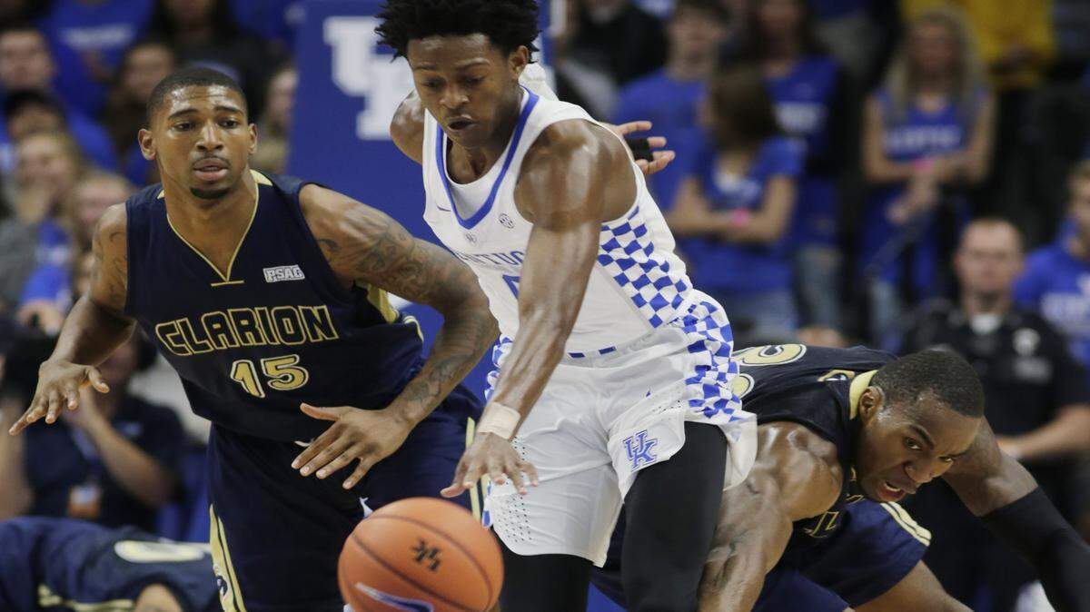 Kentucky's De'Aaron Fox (0) out maneuvered Clarion's Jamani Pierce (15) and Akeem Williams, right, in the first half of the Clarion at Kentucky men's basketball game at Rupp Arena Sunday night.