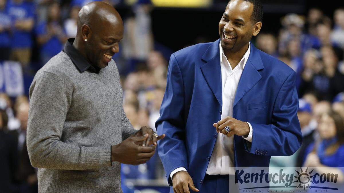Tony Delk, left and Derek Anderson admired the commemorative rings that members of Kentucky's 1996 national championship team received Wednesday.  Photo by Mark Cornelison | Staff