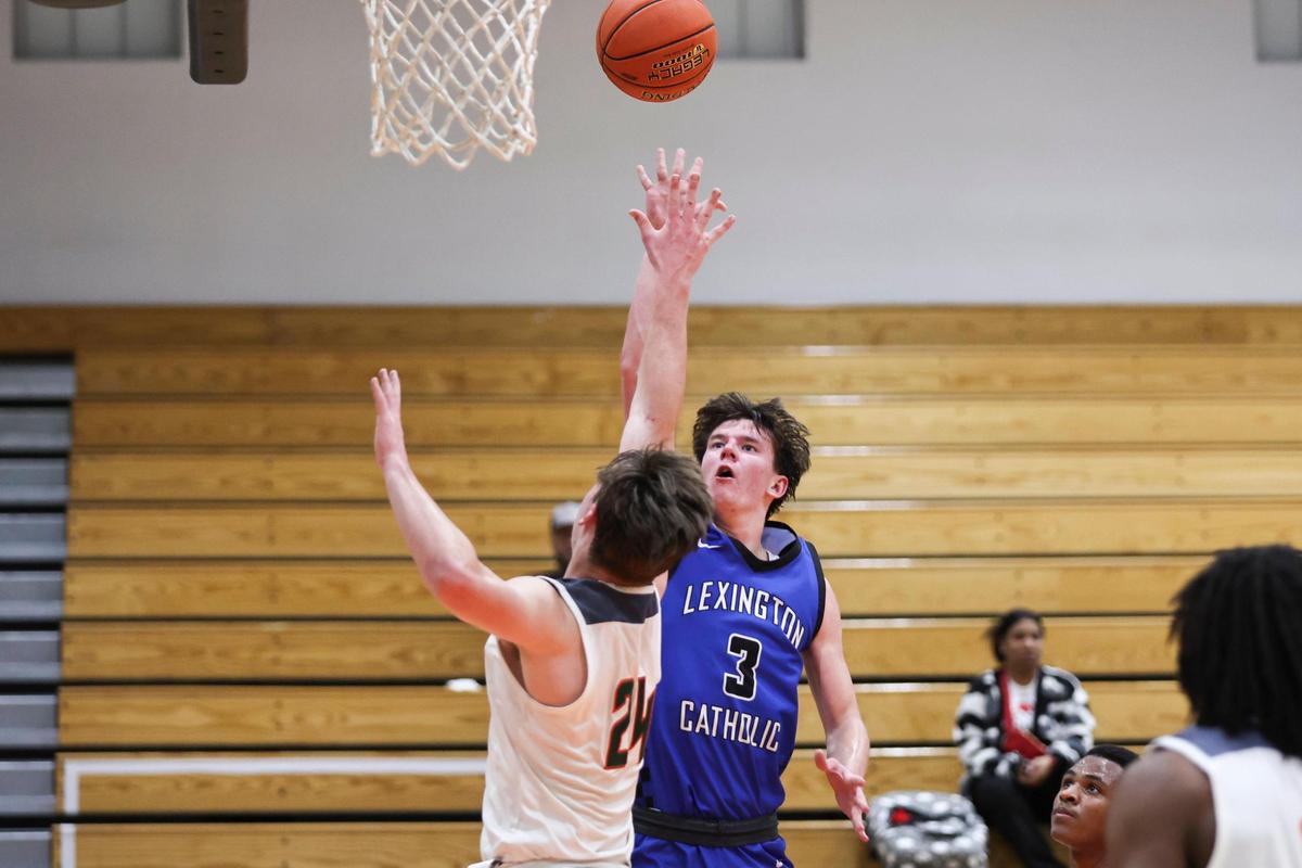 Lexington Catholic’s Tyler Doyle (3) shoots over Logan Busson of Frederick Douglass during the Knights’ 62-56 win at Frederick Douglass High School on Wednesday. Doyle led the Knights with 21 points.