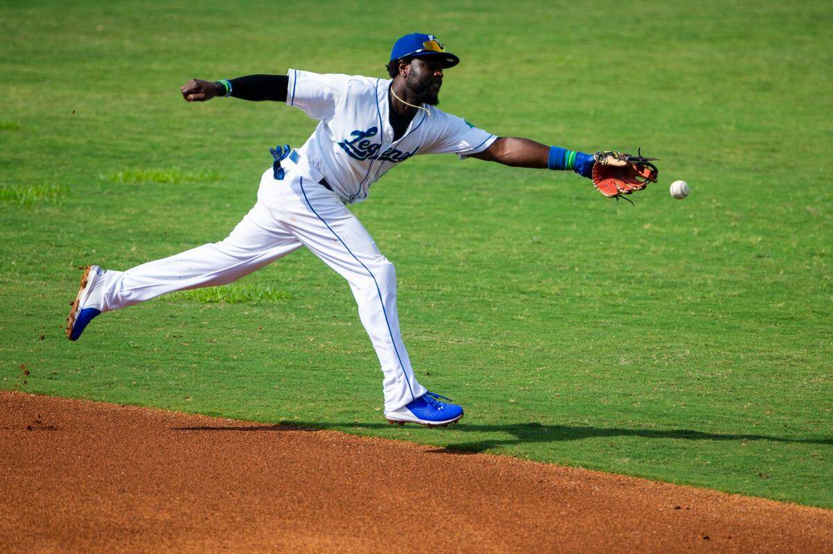 Lexington Legends second baseman Brandon Phillips (4) stretches trying to reach a ground ball hit between second and first base during a game at Lexington Legends Ballpark in July. Phillips is one of the most sought after players on the Legends for pregame autographs, often signing memorabilia connected to his time with the Cincinnati Reds.