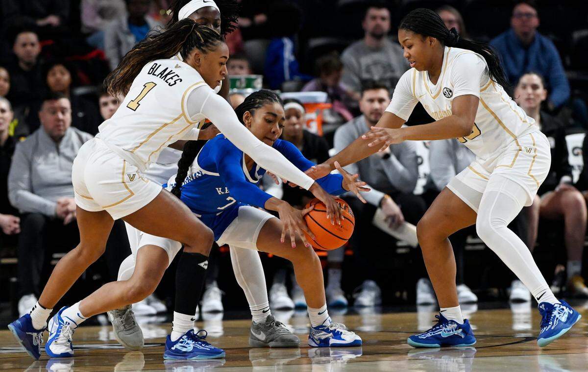 Vanderbilt's Mikayla Blakes (1) and Iyana Moore (23) battle for the ball with Kentucky forward Teonni Key (7) during an NCAA college basketball game Sunday, Jan. 5, 2025, in Nashville, Tenn.