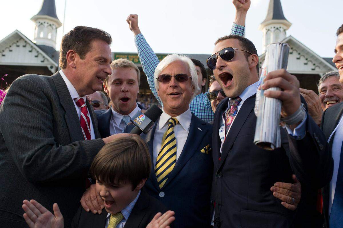Trainer Bob Baffert, center, is interviewed with Zayat Stables’ Justin Zayat after American Pharoah’s win in the 141st running of the Kentucky Derby in 2014.