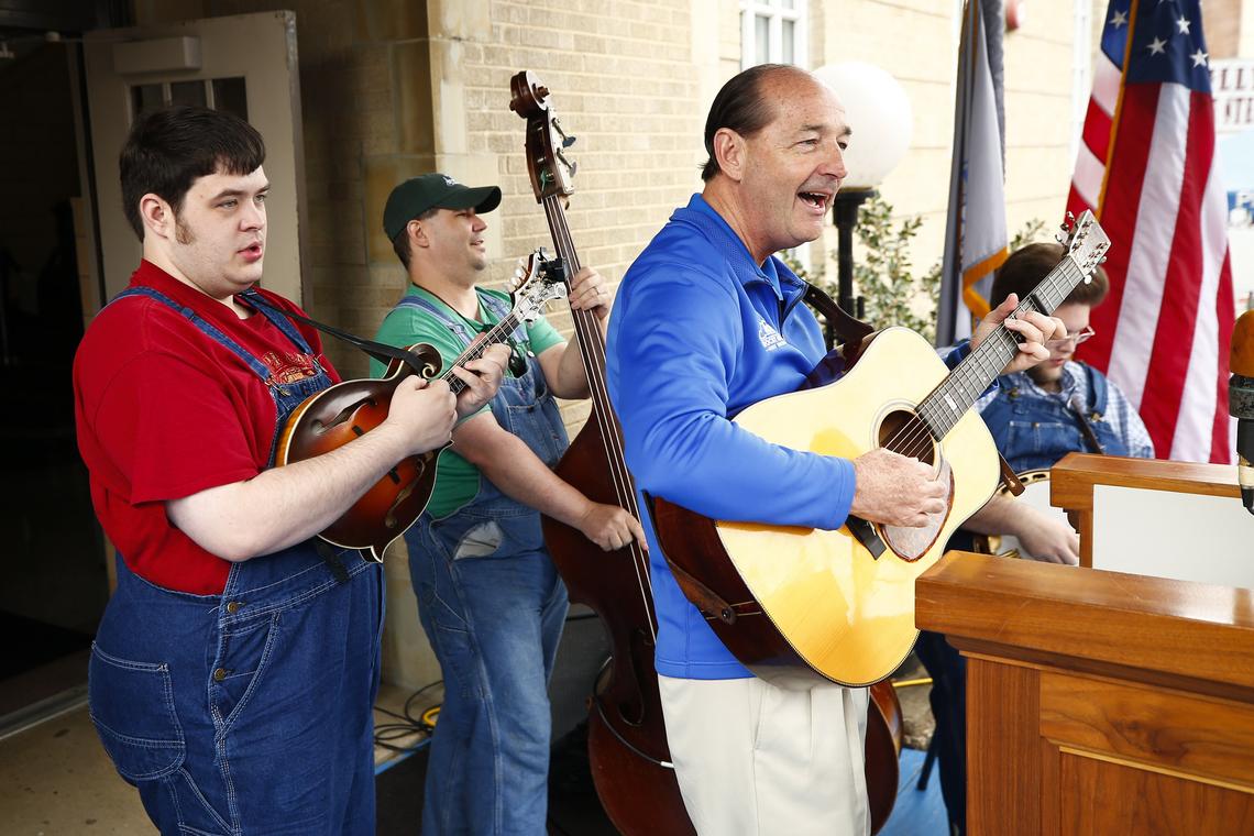 Democratic gubernatorial candidate Rocky Adkins, right, performed with The Kevin Prater Band in front of the Pike County Courthouse during Hillbilly Days in downtown Pikeville.