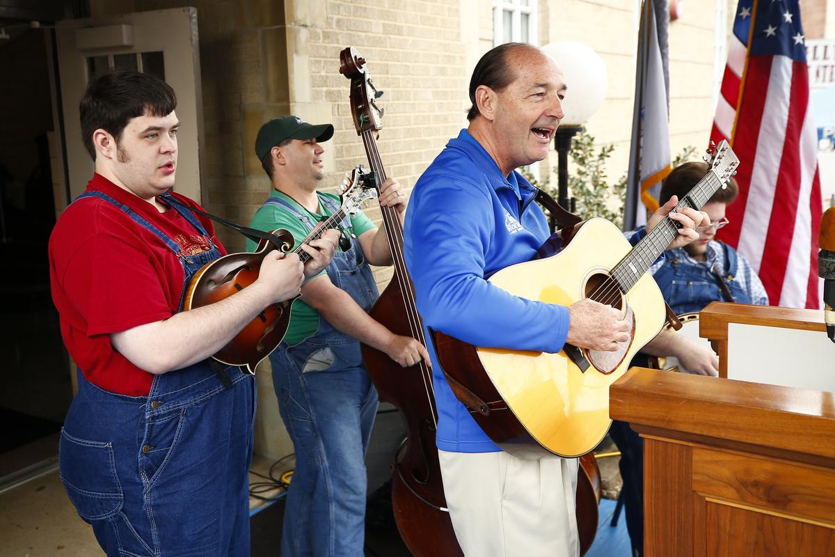 Democratic gubernatorial candidate Rocky Adkins, right, performed with The Kevin Prater Band in front of the Pike County Courthouse during Hillbilly Days Saturday in downtown Pikeville.