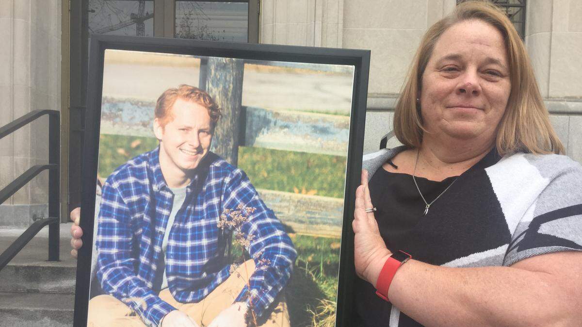 Kelley Wirth held a framed photo of her son, Mason Reppen, outside the U.S. District Courthouse in Lexington. Reppen, 22, died in 2017 of a fentanyl overdose. Clay Jennings was sentenced to 15 years on a charge in connection with selling the fentanyl that resulted in Reppen’s death. Greg Kocher, Lexington Herald-Leader
