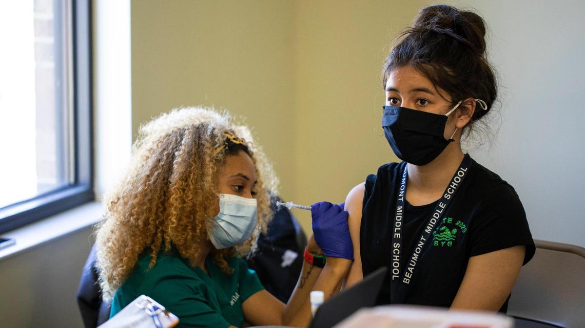 Katie Carter, 12, receives her first COVID-19 vaccination shot at STEAM Academy in Lexington, Ky., Thursday, May 13, 2021. Close to 60 children 12 and up where scheduled to receive the vaccine at STEAM Academy today.