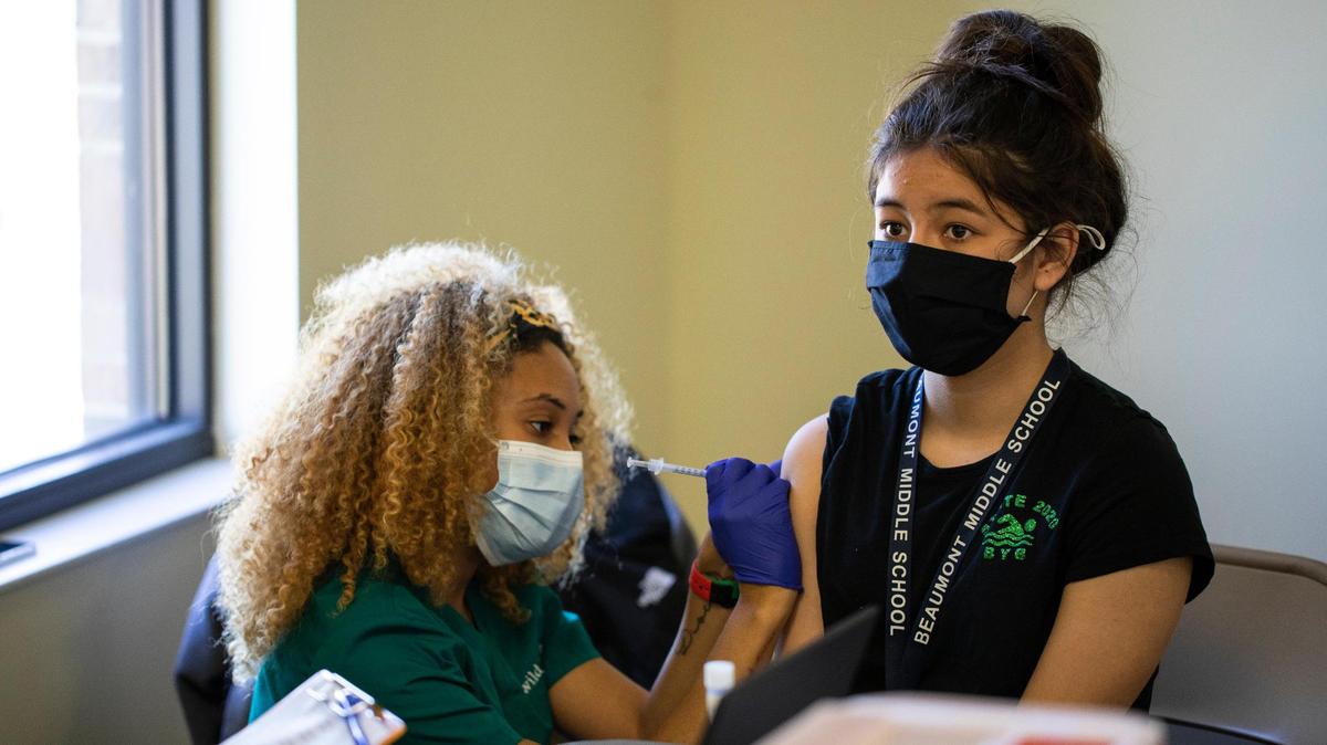 Katie Carter, 12, receives her first COVID-19 vaccination shot at STEAM Academy in Lexington, Ky., Thursday, May 13, 2021. Close to 60 children 12 and up where scheduled to receive the vaccine at STEAM Academy today.