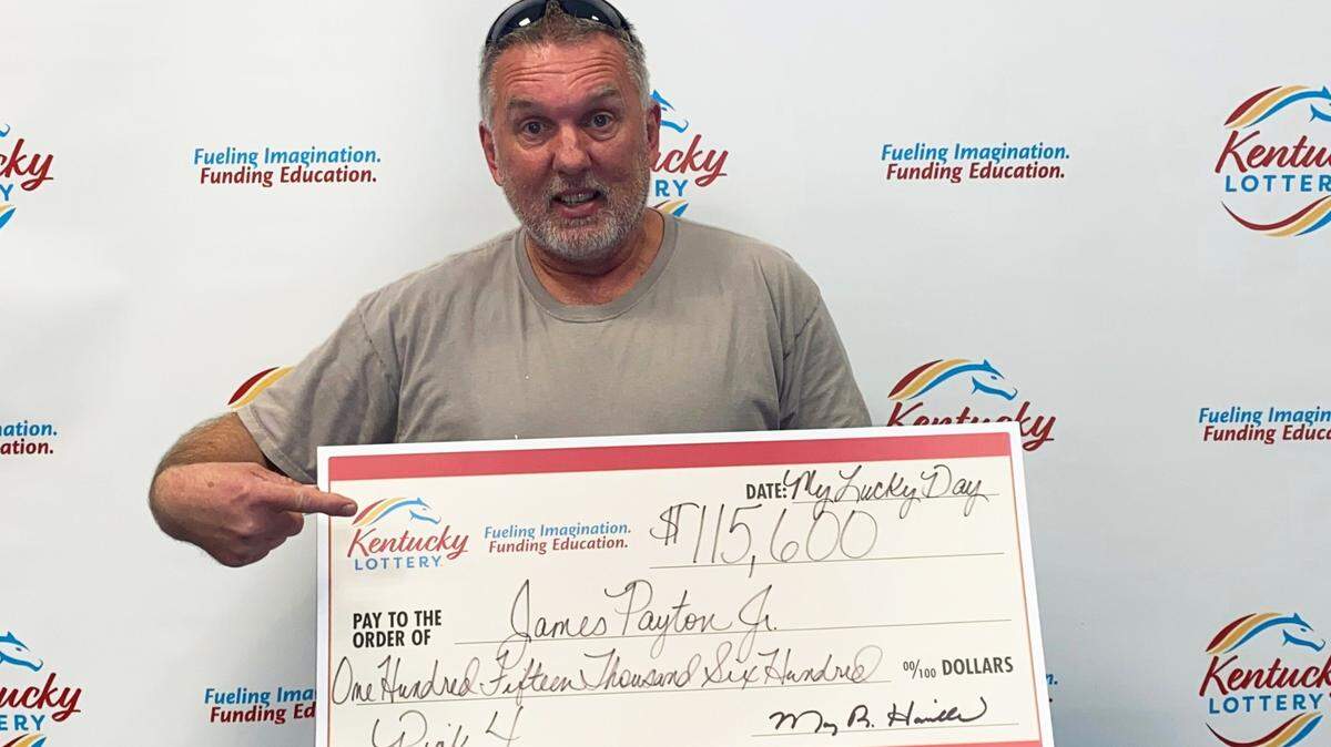 Edmonson County man James Payton Jr. poses with a check of his Kentucky Lottery winnings at state lottery headquarters in Louisville. 