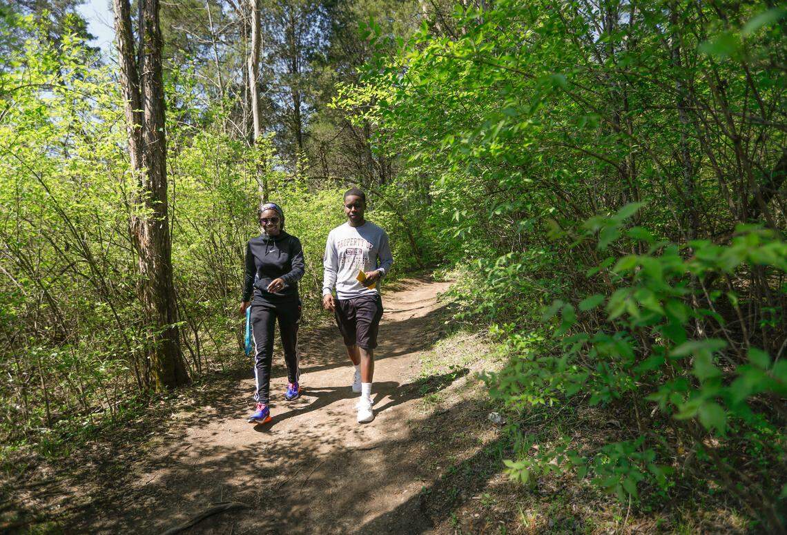 Two hikers explore a trail at Raven Run, a vast nature sanctuary in Lexington, Ky. 