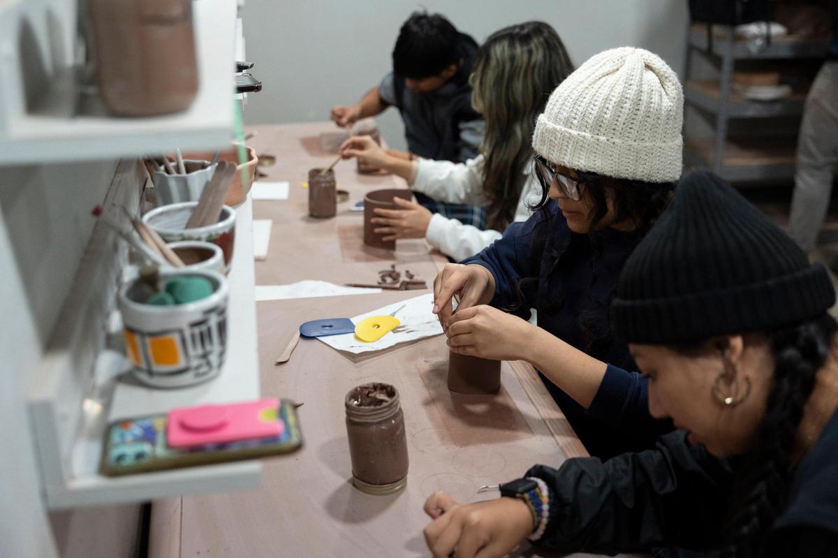 Student-workers start to create ceramic goods to fulfill orders at Matchstick Goods, a subsidiary of non-profit Common Good, at the workshop in Embrace Church in Lexington, Ky, Thursday, November 30, 2023. The North Lexington youth work on arts projects that can be sold at market and provide them with workplace experience.