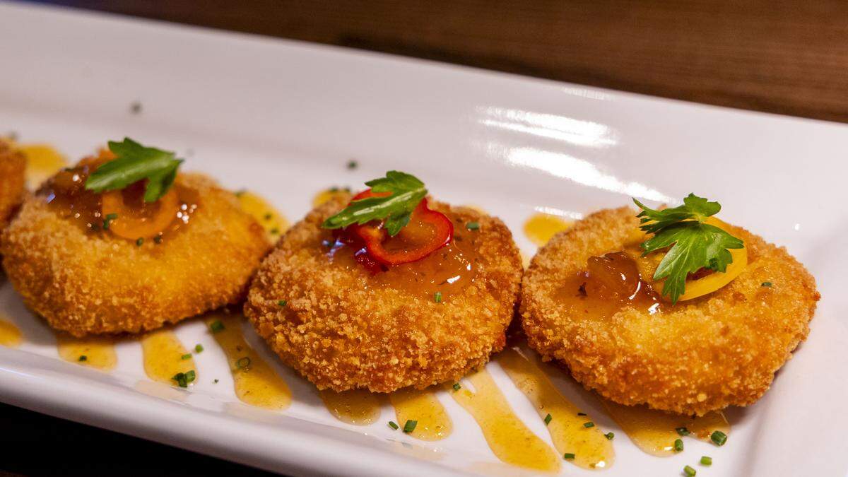Pimento Cheese Fritters appetizer at Carson’s Back Porch is prepared with house-made pimento cheese and served with a spicy peach chutney. There are nine other appetizers on the menu including seared ahi tuna, baked garlic butter oysters and bacon wrapped filet bites. 