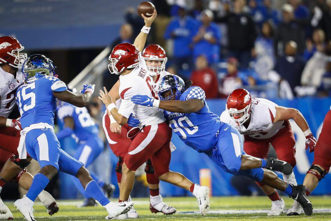 Kentucky defensive end T.J. Carter (90) tackled Arkansas quarterback Ben Hicks (6) during Saturday night’s UK win.
