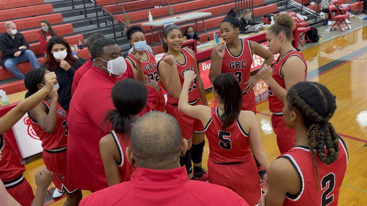 Clark County Coach Robbie Graham talked to his team, including sisters Brianna Byars (23) and Ciara Byars (3), center, in the team huddle during a timeout in their game against Bowling Green at Butler Traditional High School on Saturday.