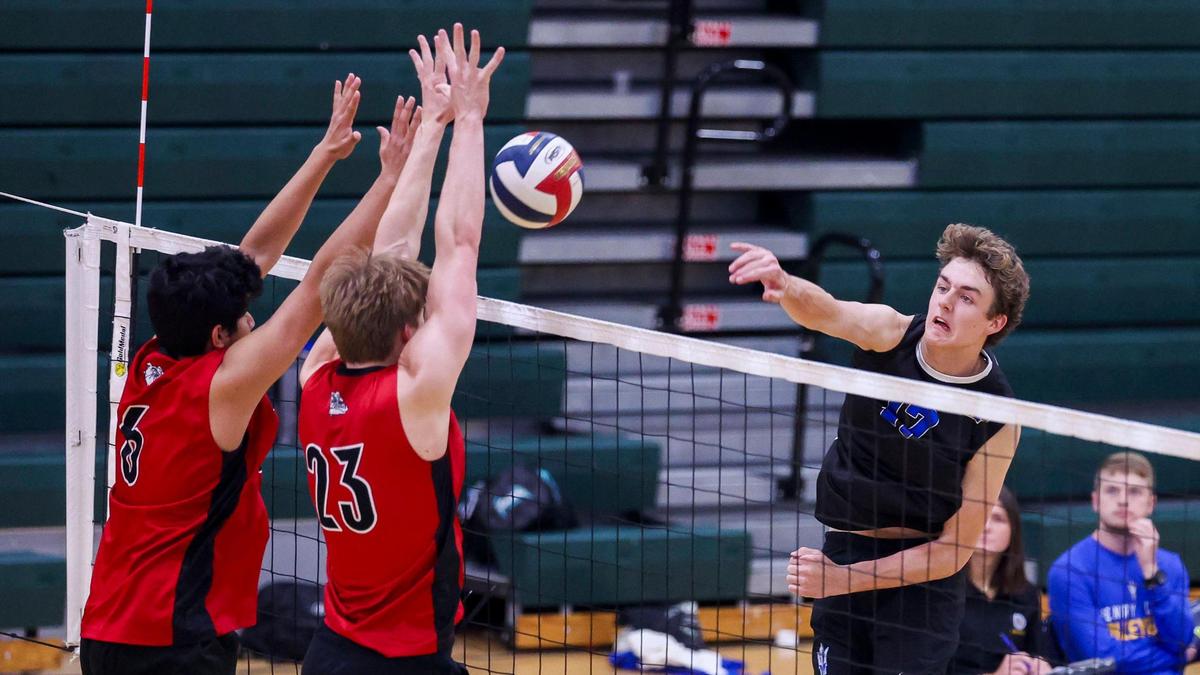 Henry Clay’s Gray Millar (17) spikes the ball past the defense of Paul Laurence Dunbar’s Esteban Diaz (6) and William Naehr (23) during the 7th Region Boys Volleyball Tournament on Thursday at Bryan Station High School.
