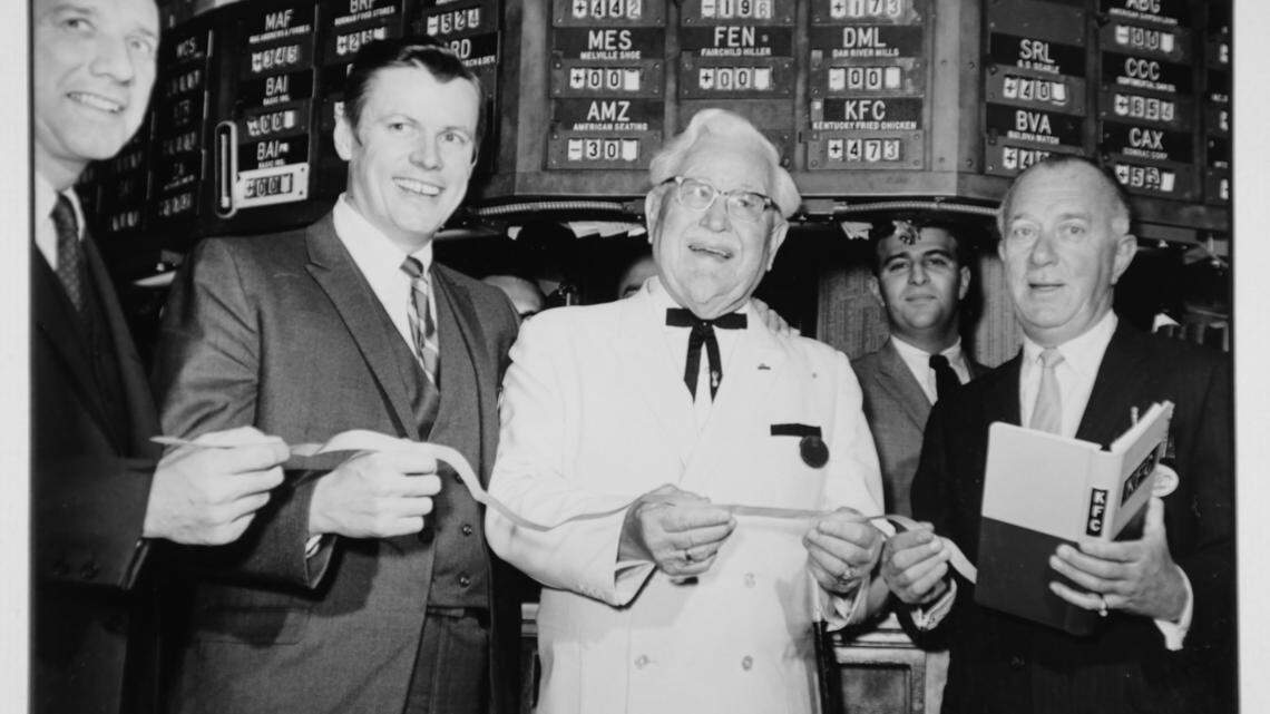 John Y. Brown and Col. Harland Sanders visited the New York Stock Exchange; the company's stock was listed on the NYSE starting in 1969.