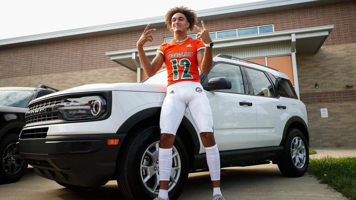Frederick Douglass wide receiver Dane Key (12) poses for a portrait in front of a Ford Bronco during a team photo shoot at Frederick Douglass High School on July 23, 2021.