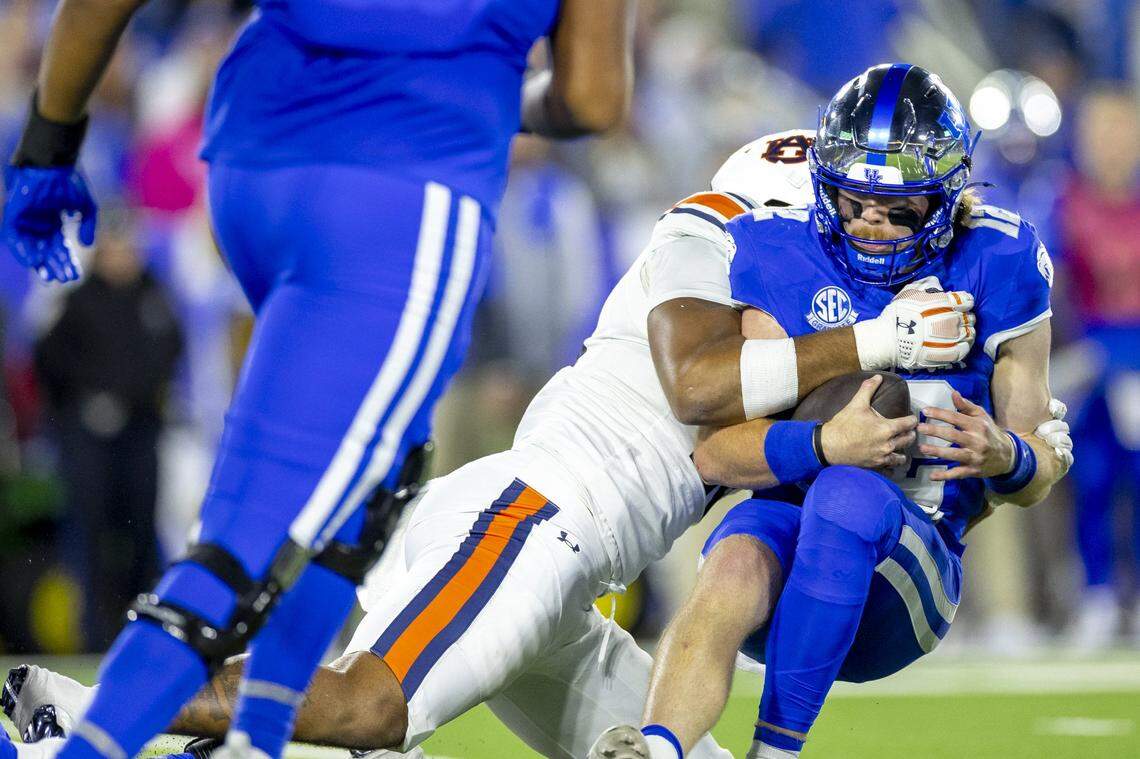 Kentucky quarterback Brock Vandagriff (12) is tackled by Auburn cornerback Kayin Lee (4) during Saturday’s game at Kroger Field. The Tigers’ defense recorded three sacks and limited UK to 224 total yards.