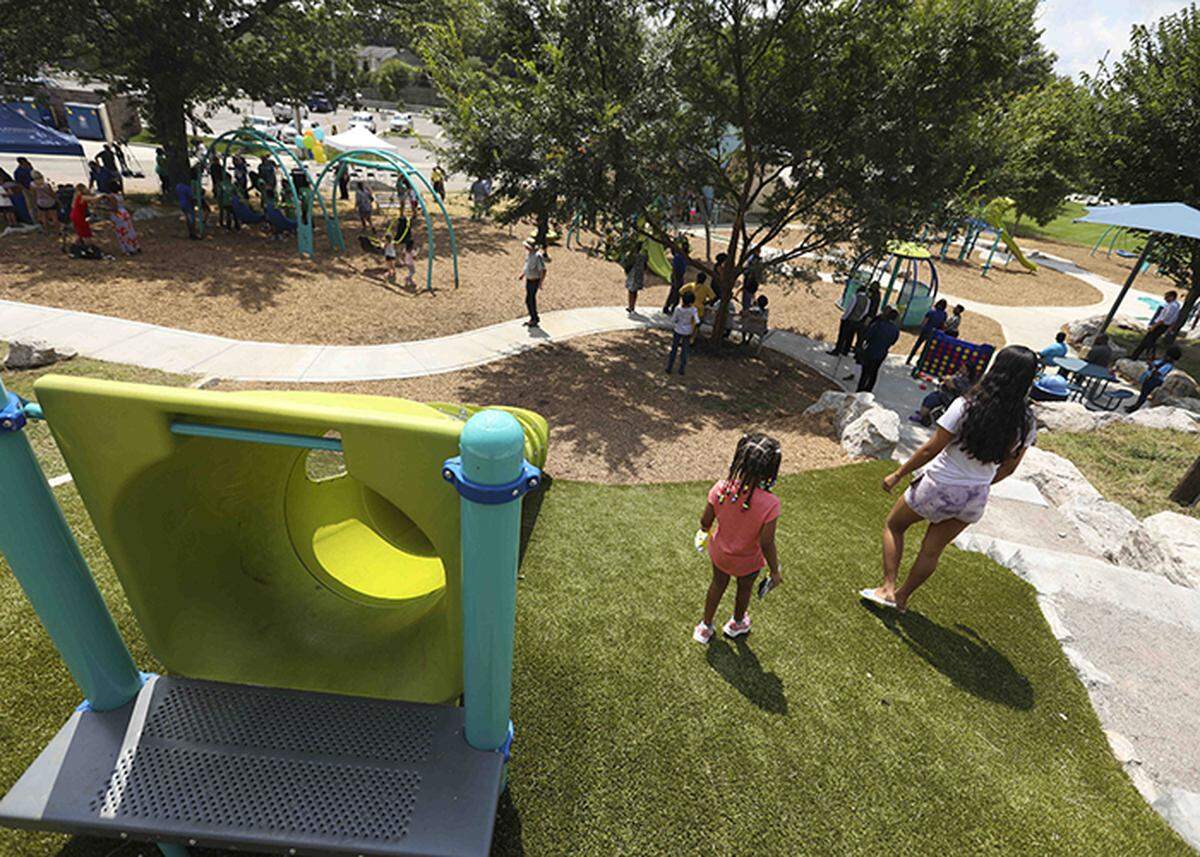 People checked out the new playground at Charles Young Park at a ribbon cutting Aug. 20.