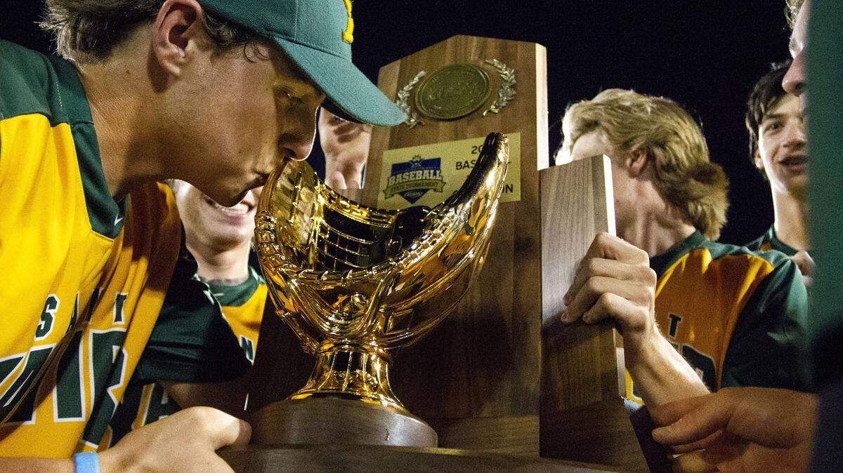 St. Xavier’s Alex Smith kissed the Kentucky state championship trophy after his team’s win against Highlands.