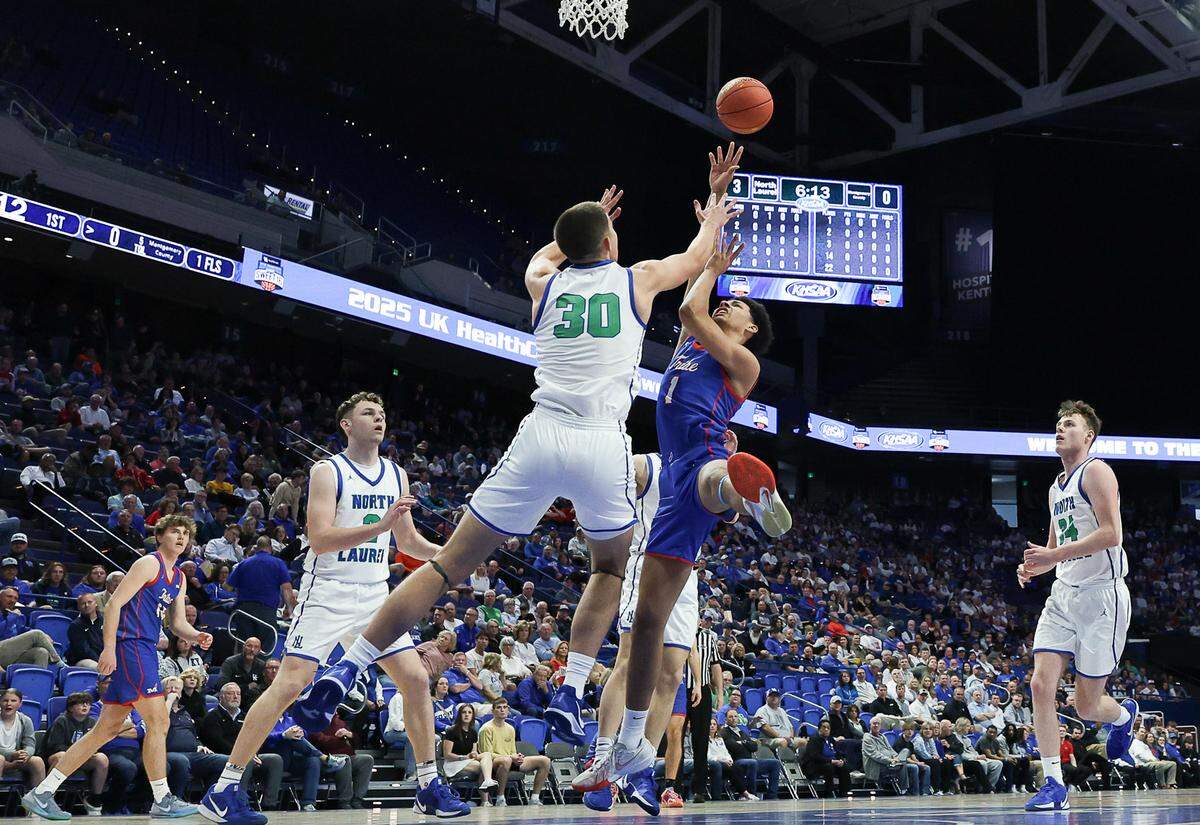 North Laurel’s Reece Davidson blocks a shot by Montgomery’s Tyce Jarvis during their Boys’ Sweet 16 game Friday.