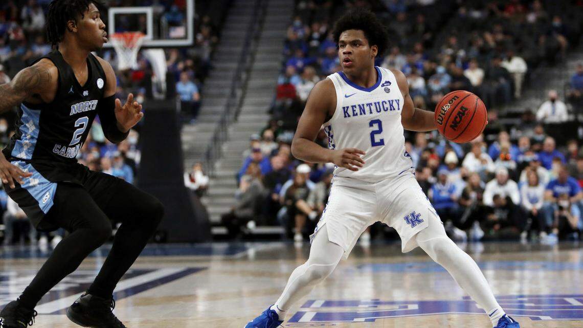 Kentucky’s Sahvir Wheeler (2) looks for the open pass against North Carolina’s Caleb Love (2) during the second half of an NCAA college basketball game, Saturday, Dec. 18, 2021, in Las Vegas.
