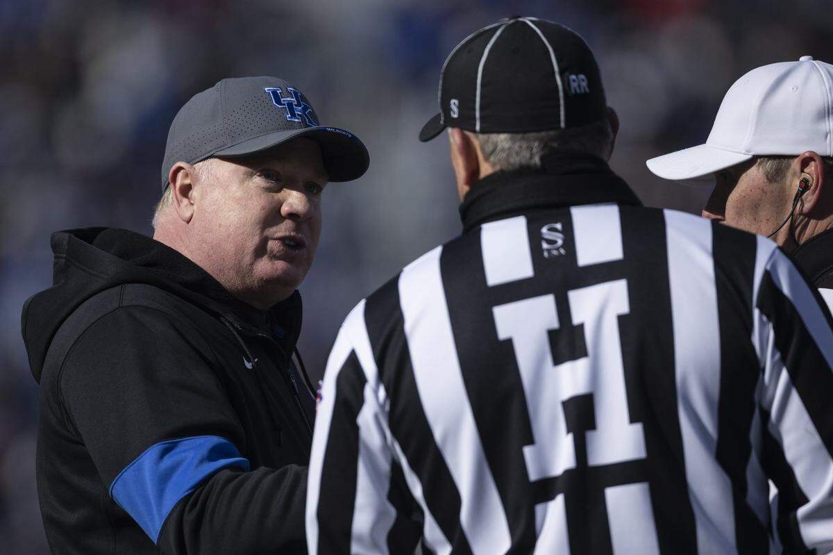 Kentucky head coach Mark Stoops speaks with officials during Saturday’s Governor’s Cup game against Louisville at Kroger Field.