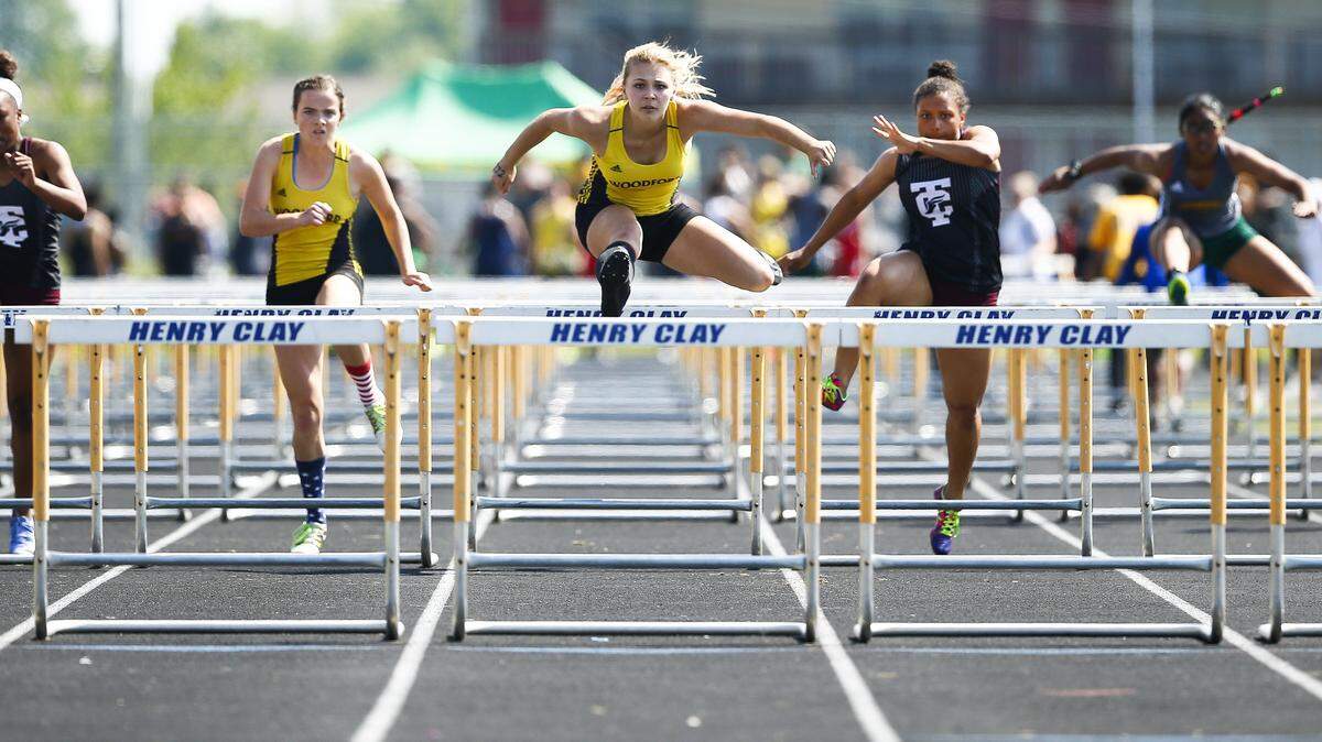 Woodford County's Callie Gormley, center, cleared the final hurdle to win the girls 100 meter hurdle event during the Class 3A, 6th Region track meet Saturday at Henry Clay High School. 