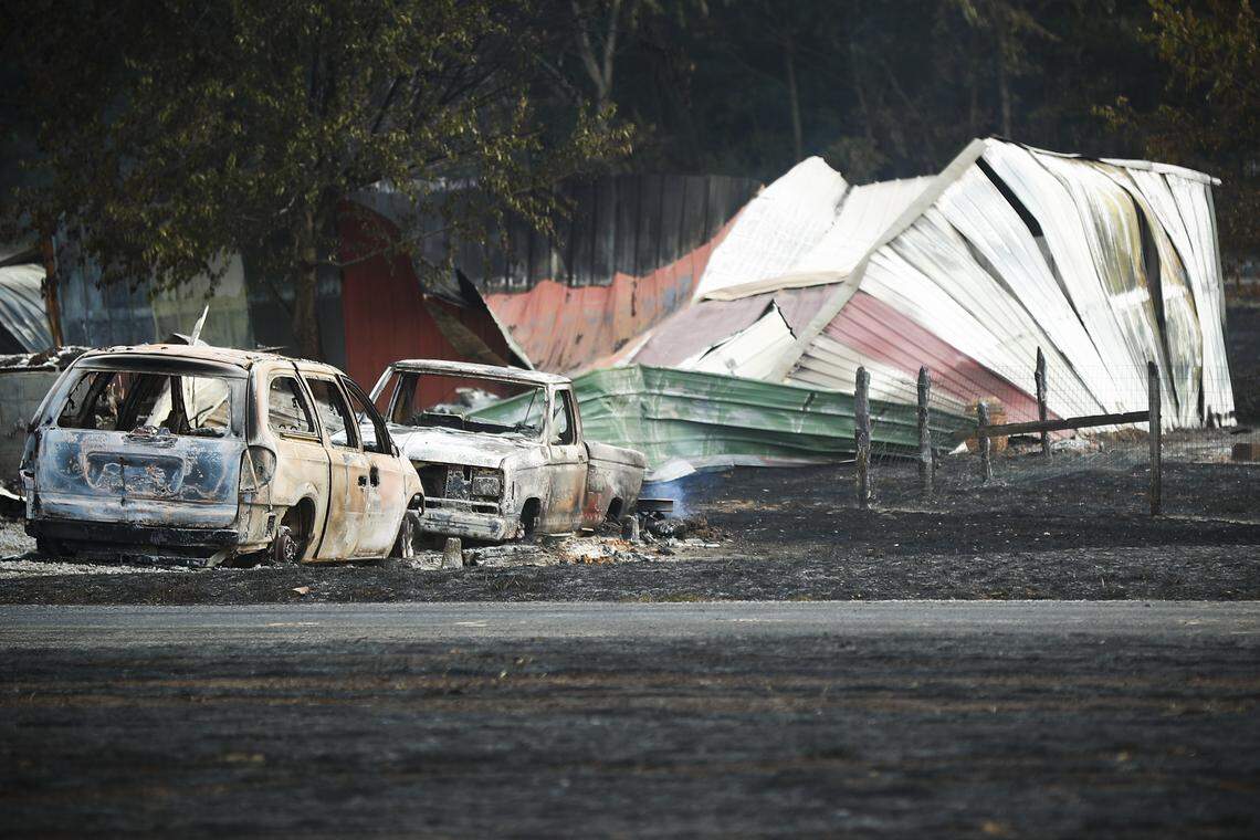 Burnt vehicles and destroyed buildings sit near the site of a gas line explosion that left one woman dead in Moreland, Ky., Thursday, Aug. 1, 2019.