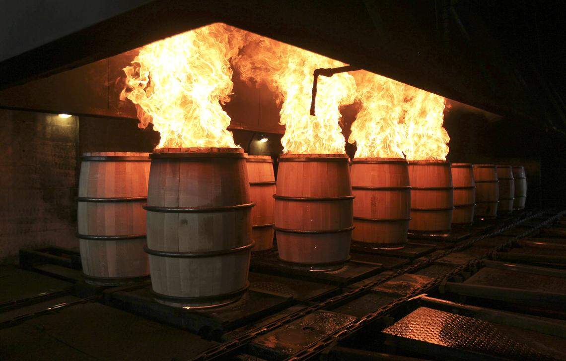 Freshly made barrels being fired the Brown-Forman cooperage in Louisville in 2013. When barrels are fired they are equipped with heavy-duty rings that can withstand the flames. Those are replaced down the line. Brown-Forman announced on Jan. 14 that it will close its cooperage by April 25 and lay off more than 200 workers there.