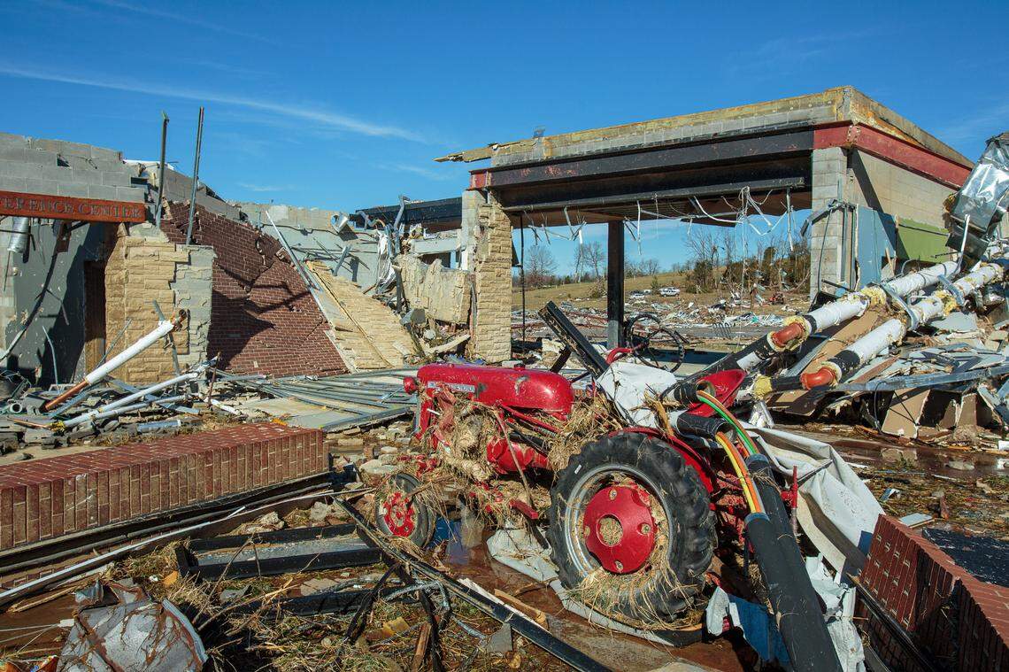 A vintage tractor sits in the rubble of the Grain and Forage Center of Excellence at the University of Kentucky Research and Education Center, which was damaged by a powerful tornado in December 2021.