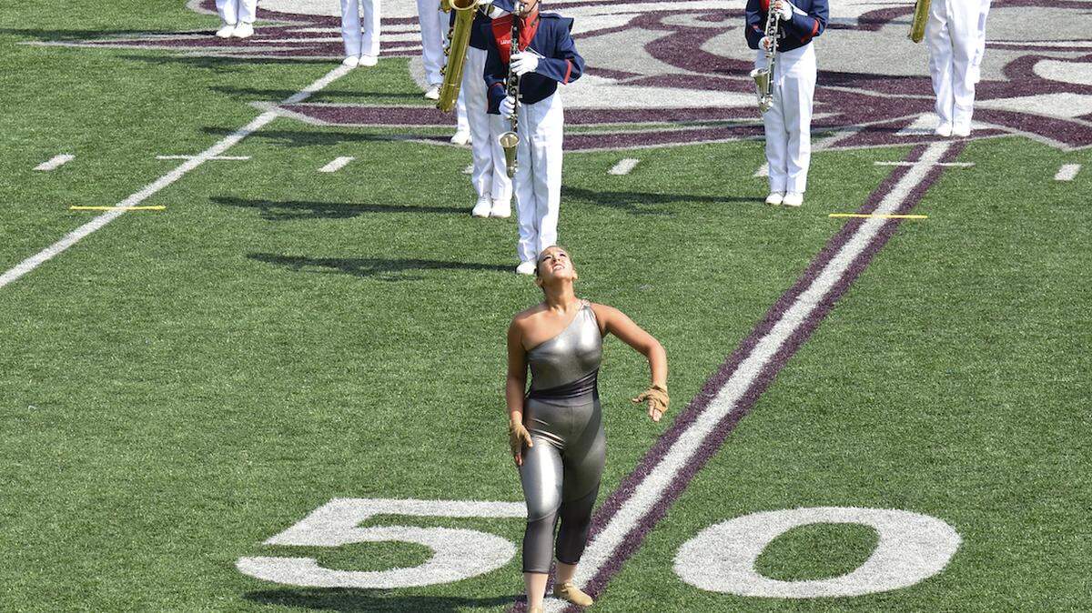 Lafayette High School marching band color guard captain Niki Arens, center, tossed her rifle during a performance of the band's 2011 show, "Shadows of Eternity," at the Bands of America regional competition on Sept. 24 at Eastern Kentucky University in Richmond.       