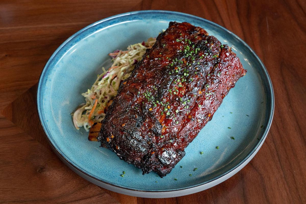Local Berea College Smoked Ribs ($25) at Crafted at Boone Tavern, the restaurant at the Historic Boone Tavern Hotel in Berea, Ky. The half rack of ribs is served with a mac ploy sweet chili glaze, broccoli slaw with pipits and cranberries.