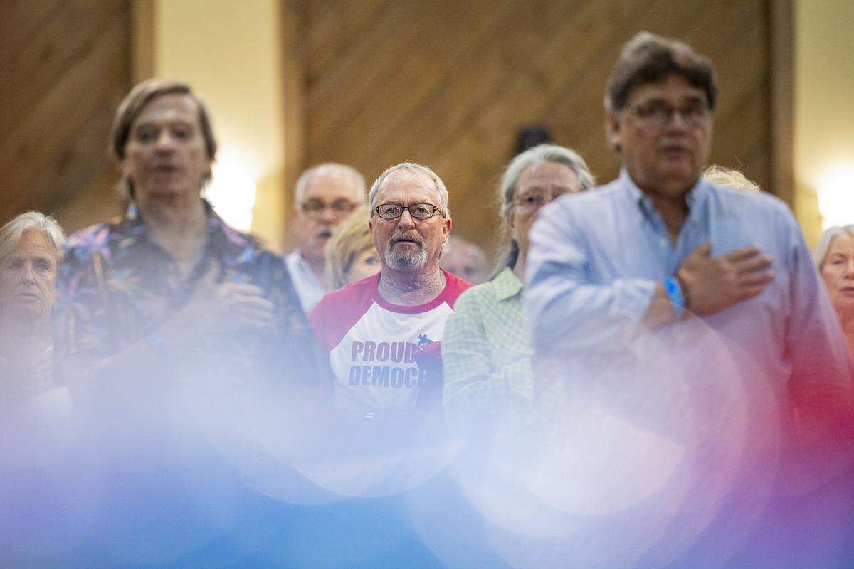 Marshall County Democrats stand for the national anthem during the Democratic Fancy Farm dinner on Friday, Aug. 1, 2025, at the KY Dam Convention Center in Gilbertsville, Ky.