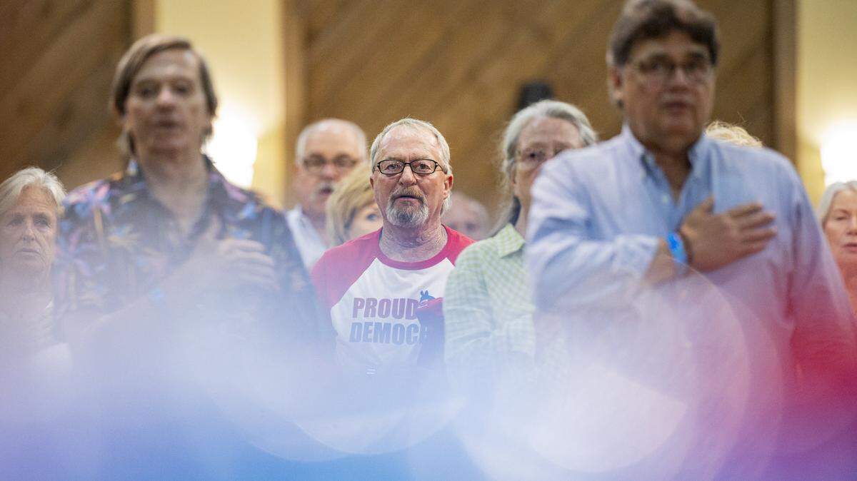 Marshall County Democrats stand for the national anthem during the Democratic Fancy Farm dinner on Friday, Aug. 1, 2025, at the KY Dam Convention Center in Gilbertsville, Ky.
