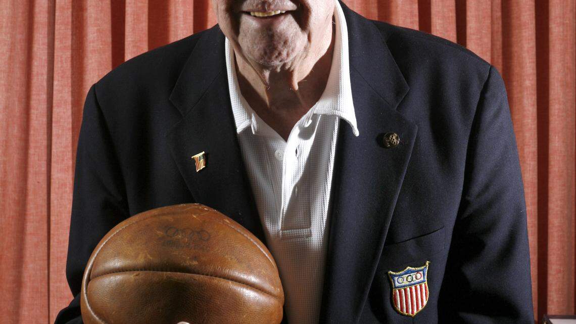 Wallace "Wah Wah" Jones, wearing a blazer bearing his original United States Olympic team patch from 1948, held the ball he rebounded from the last shot taken in the gold medal game.    