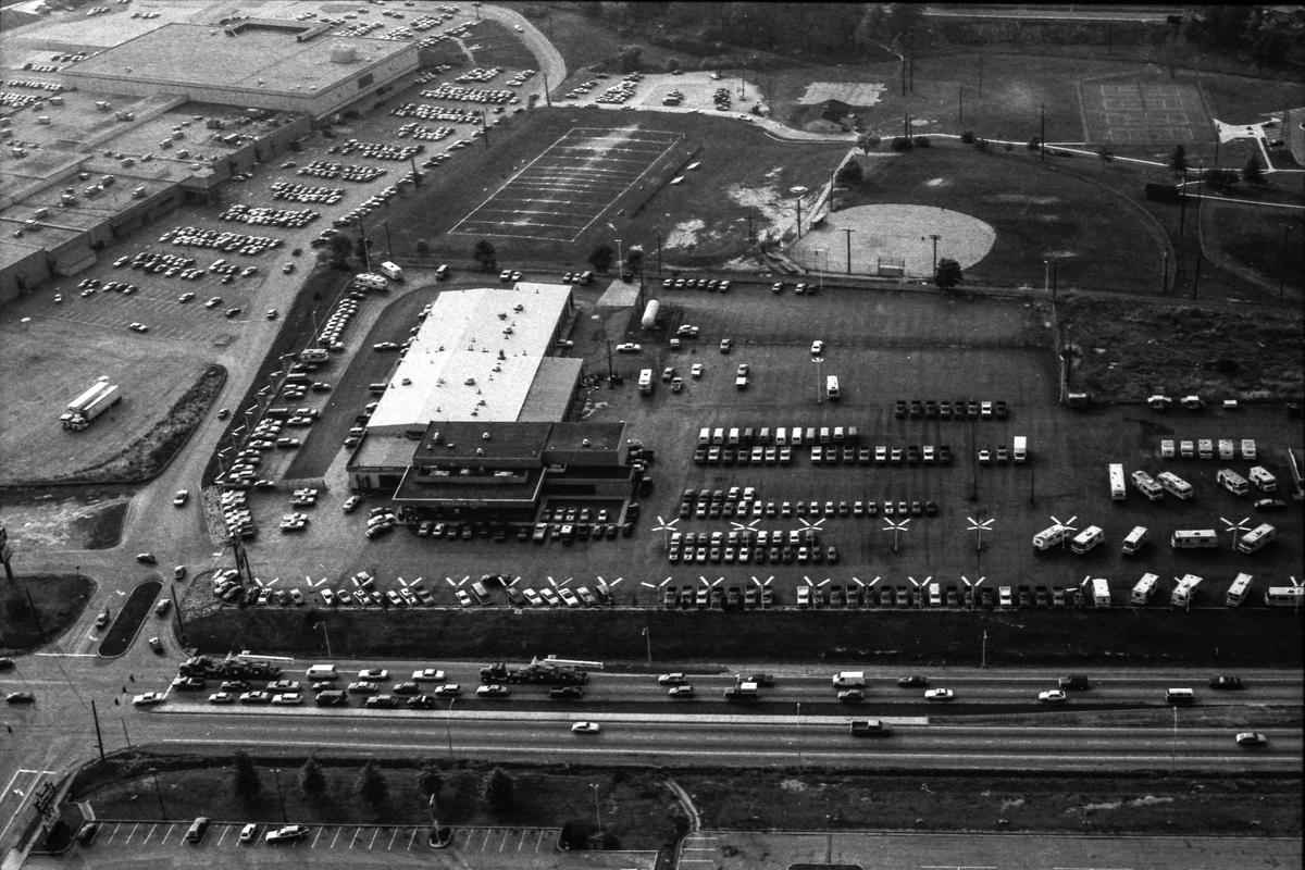 Freedom Dodge auto and truck dealership on Oct. 4, 1982, which opened just over a year earlier at this location on Lexington’s New Circle Road. The auto dealer had been known as Lexington Dodge but closed in Feb. 1981 for financial reasons. Directly behind the car dealer is Idle Hour Park, which then played host to Lexington Parks and Recreation youth football, t-ball, softball and baseball teams. In the upper left corner is the backside of Lexington Mall, anchored by McAlpin’s department store, which had another store in Turfland Mall. Some of the other stores in the mall at this time included Dawahares, Morrison’s Cafeteria, Lexington Mall Twin Cinemas, Wenneker’s, Fashion Shop, Schwab’s Pipes and Stuff, Gateway Books, Phillip Gall & Son and LeRoy’s Jewelers.