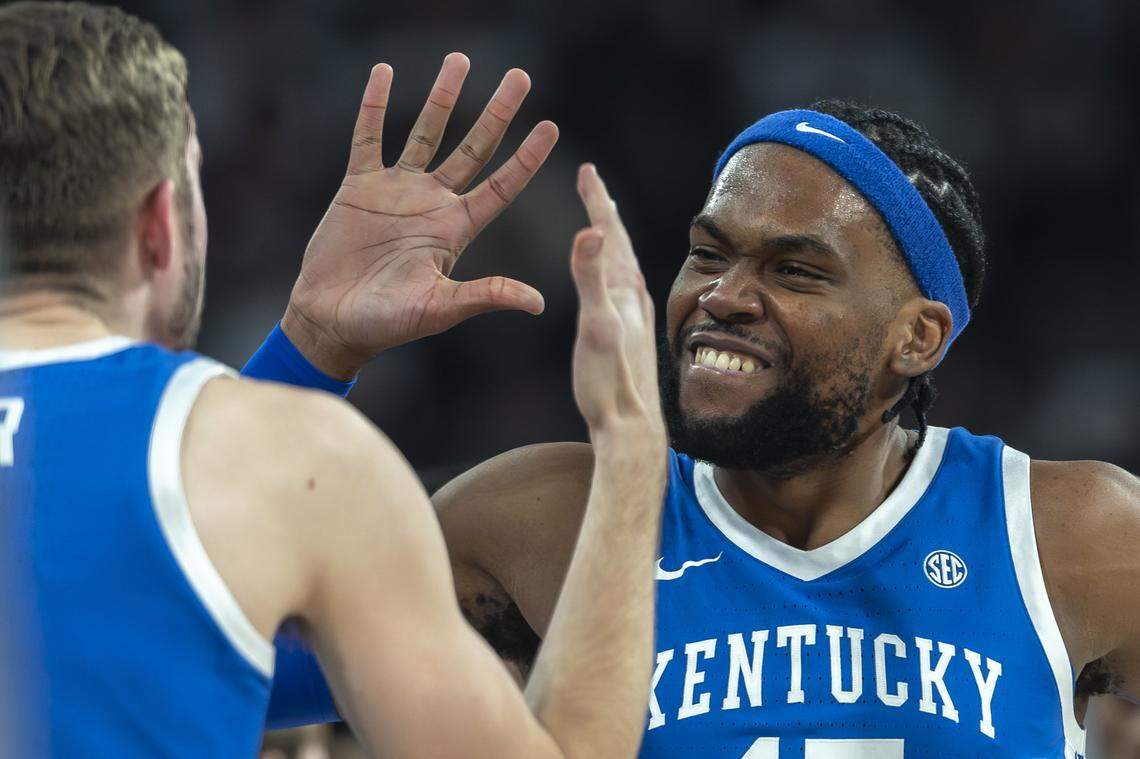 Kentucky’s Andrew Carr, left, and Ansley Almonor celebrate during Saturday’s win at Mississippi State.