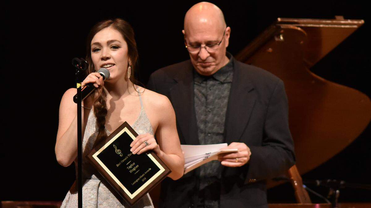 Kentucky native Taylor Hughes, left, accepts the award for best female vocalist presented by Max Corona at the 4th annual Lexington Music Awards in 2018. The country artist and songwriter won three awards in 2019 including best female vocalist.