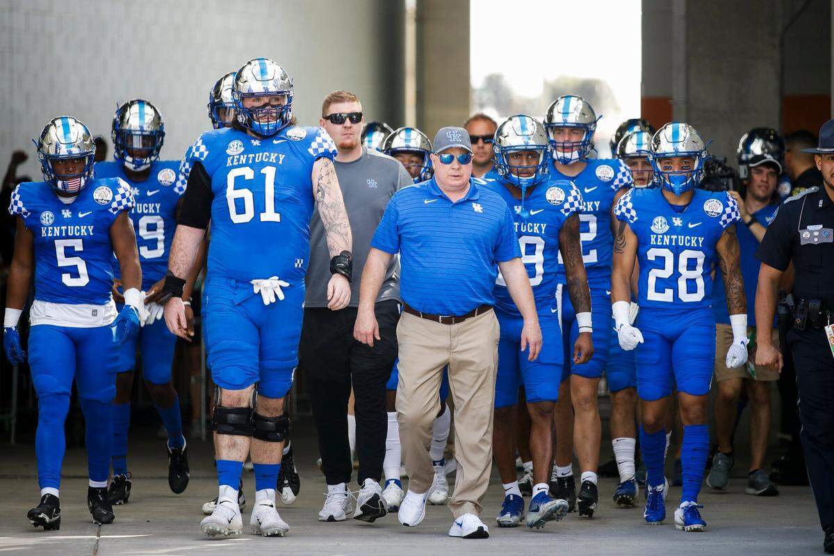 Kentucky head coach Mark Stoops leads his team onto the field before its VRBO Citrus Bowl matchup against the Iowa Hawkeyes at Camping World Stadium in Orlando, Fla., on Jan. 1. The Cats rallied for a 20-17 victory against Stoops’ alma mater.