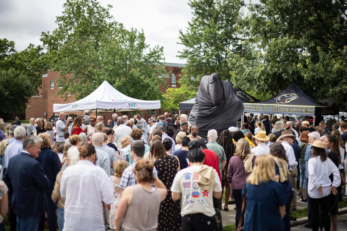 A crowd gathers during the ‘Towards Freedom’ monument unveiling on Thursday, June 19, 2025, at the corner of North Limestone and Fourth Street in Lexington, Ky.