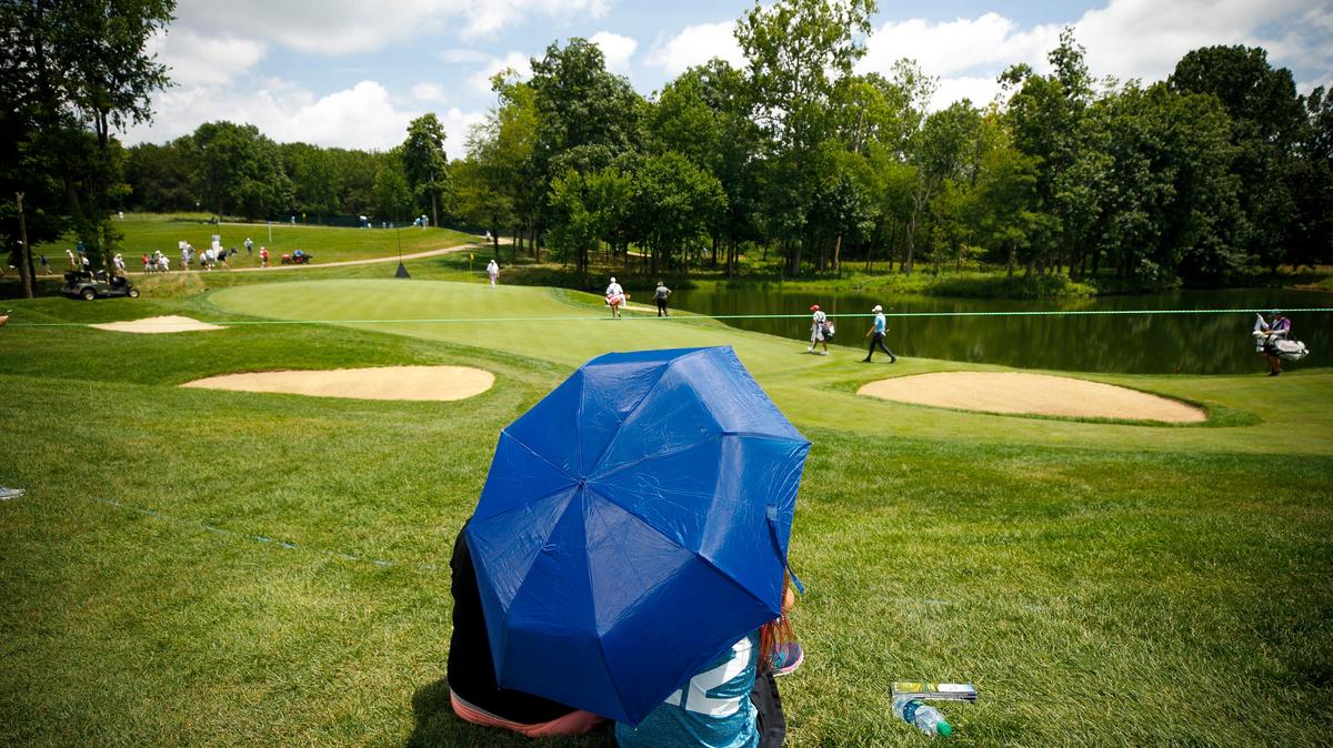 Brooke Counts, left, and Lauren Counts, 10, Both of Nicholasville, Ky., sit under an umbrella as golfers make their way to the 17th green during the PGA Barbasol Championship opening round at Keene Trace Golf Club’s Champions Course in Nicholasville, Ky., Thursday, July 18, 2019. Temperatures are expected remain in the middle 90s on Friday.
