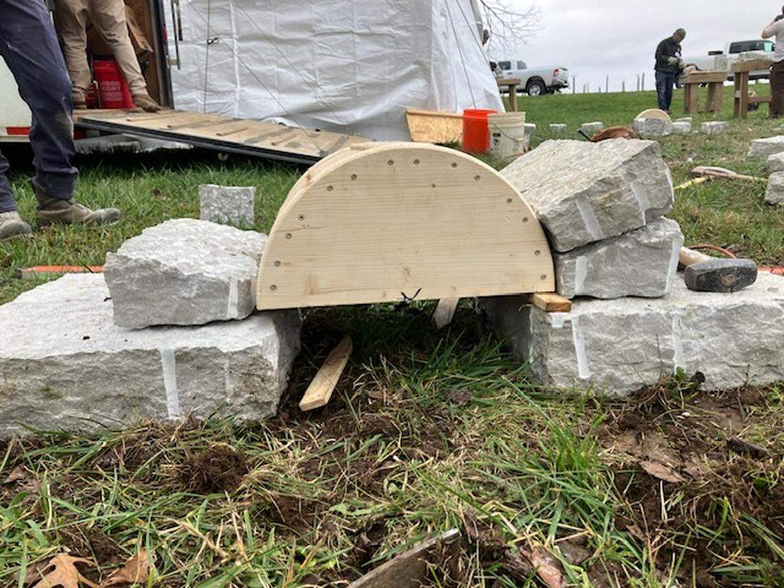 Attendees of a Dry Stone Conservancy two-day workshop on cutting and shaping stone learn to build an arch on Nov. 22, 2024.