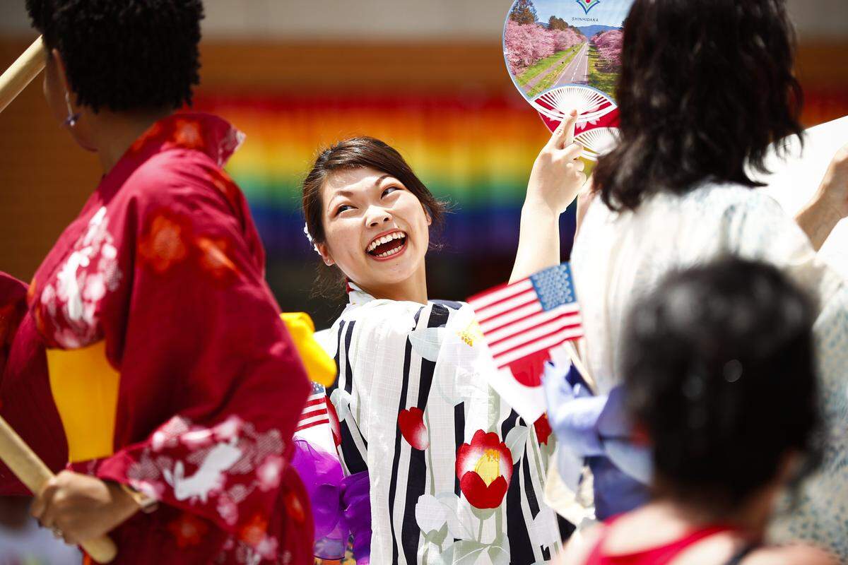 Mai Takatasuji, of Shinhidaka, Japan, laughs with other representatives from Lexington’s sister city Shinhidaka, Japan, during the city’s Fourth of July parade along Main Street in downtown Lexington Ky., Thursday, July 4, 2019.
