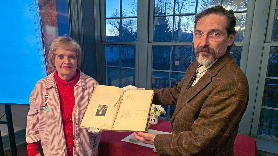 (From left) Nancy Hill, president of Harrodsburg Historical Society, and Chad Greene, president of the Friends of Perryville Battlefield, pose for a photo after handing over a hospital ledger from the Battle of Perryville to the Harrodsburg Historical Society.