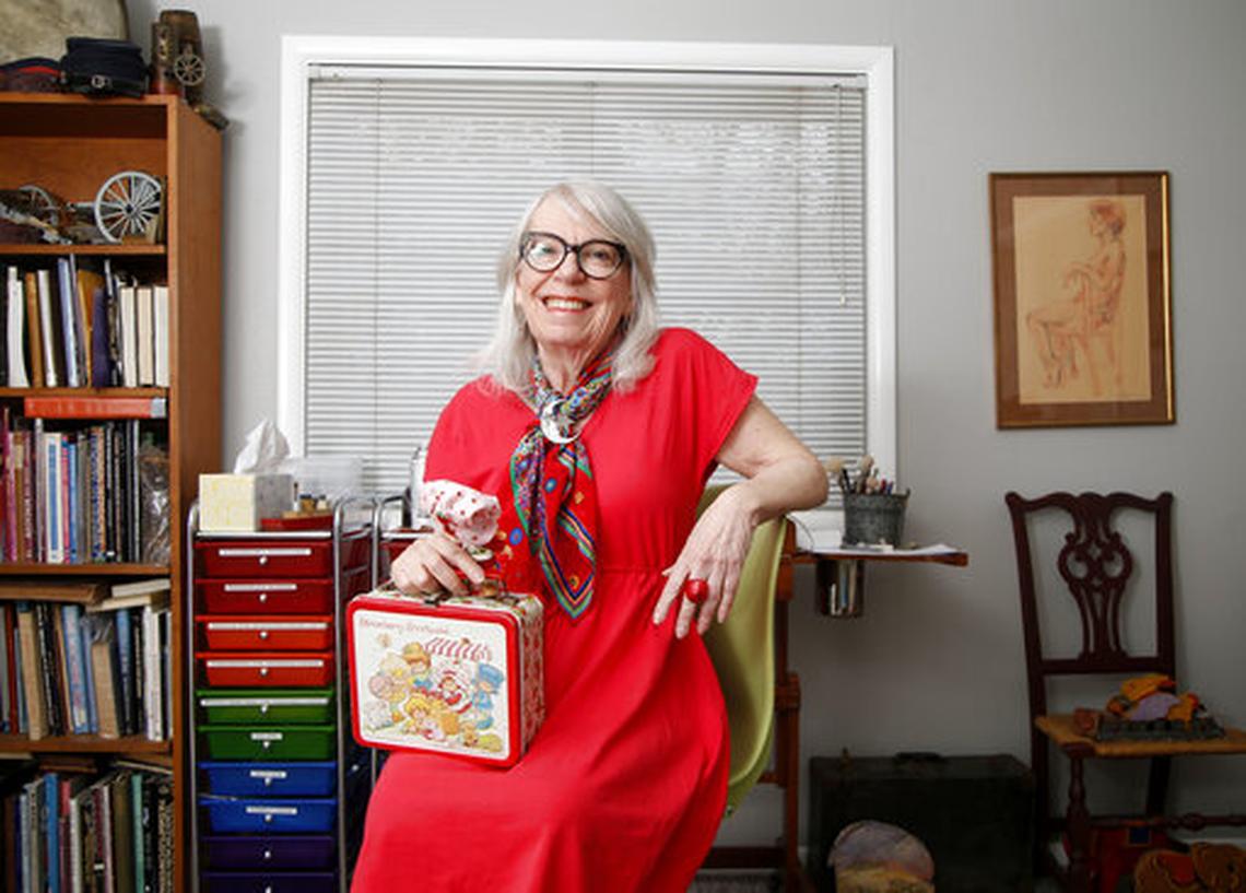 Muriel Fahrion, the creator of the Strawberry Shortake cartoon franchise, sits with a selection of memorabilia at her home studio in Tulsa, Okla., on Monday, March 25, 2019. She will be one of the many comic creators at Lexington ComicCon this weekend.